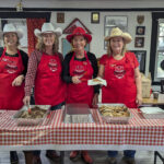 Calgary Stampede Planning Committtee Helpers feeding the hungry masses.